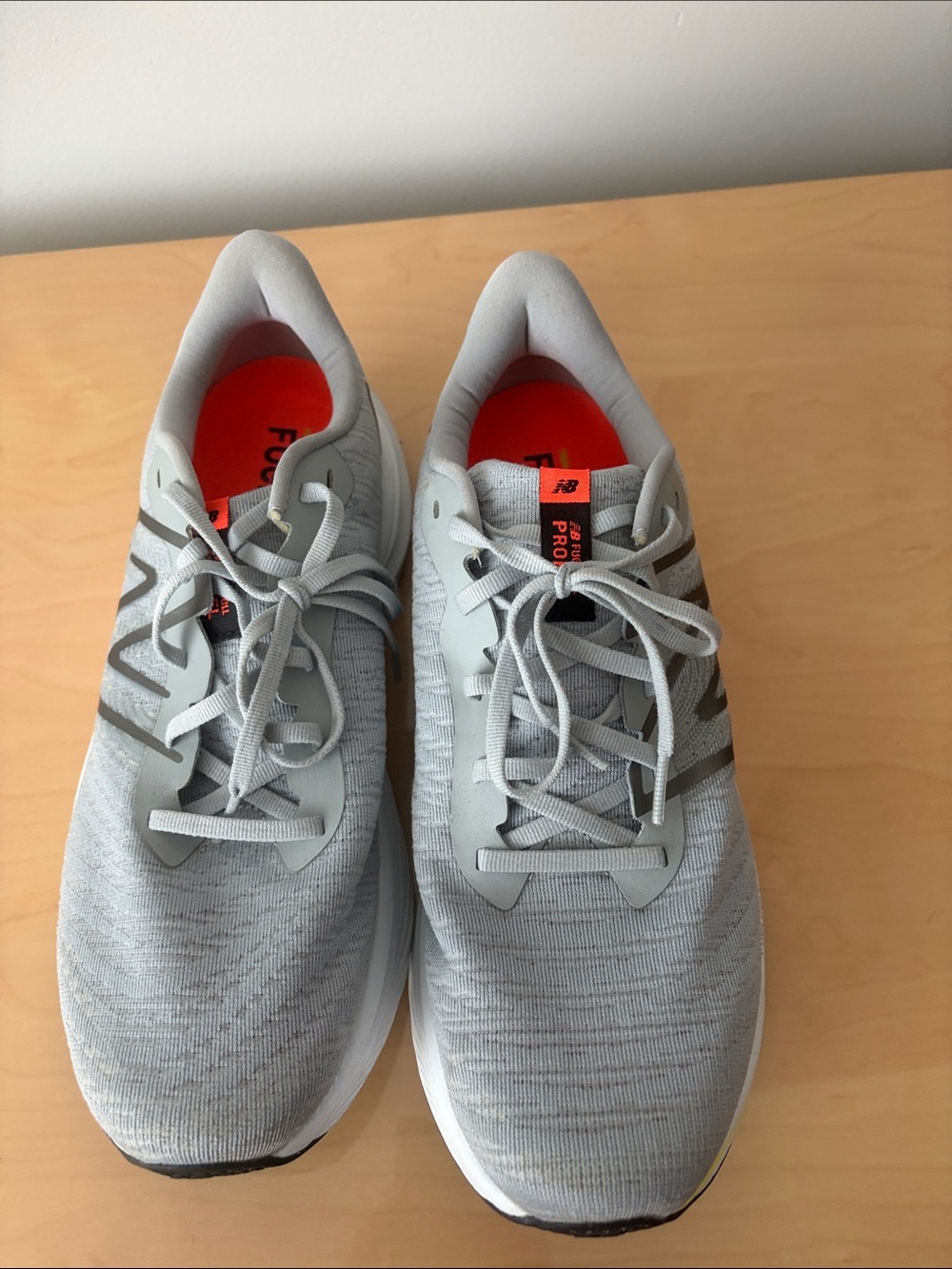 New Balance Men's Light Gray Athletic Sneakers with Orange Insole Accents